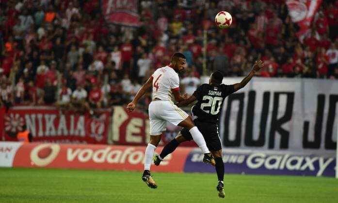 Greece: Olympiacos vs Partizan Alaixus Romao (no 4) of Olympiacos and Seydouba Soumah (no 20) of Partizan vindicate the ball during the game.  DimitriosxKarvountzis PacificxPress