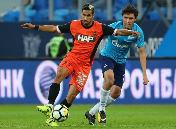 ST PETERSBURG, RUSSIA - AUGUST 3, 2017: Bnei Yehuda Tel Aviv s Almog Buzaglo (L) and Zenit St Petersburg s Yuri Zhirkov fight for the ball in the second leg of their UEFA Europa League Third qualifying round tie at Krestovsky Stadium. FC Bnei Yehuda Tel Aviv won the game 1-0. Peter Kovalev TASS  TS05A137