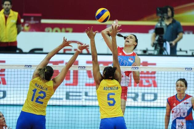 Natalia Pereira, left, and Adenizia Da Silva of Brazil spike against Stefana Veljkovic of Serbia during their match of the FIVB Volleyball World Grand Prix Finals 2017 in Nanjing city, east China s Jiangsu province, 5 August 2017. Brazil defeated Serbia 3-1 (20-25, 25-23, 25-14, 25-23). Brazil eliminates Serbia at FIVB Volleyball World Grand Prix Finals 2017  20170805_80270