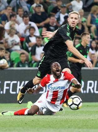 KRASNODAR, RUSSIA - AUGUST 17, 2017: Crvena Zvezda Belgrade s Guelor Kanga (front) and FC Krasnodarâ€™s Yuri Gazinsky (back) fight for the ball in their 2017 2018 UEFA Europa League Playoff 1st Leg football match at Krasnodar Stadium. Vitaly Timkiv TASS  TS05BC49