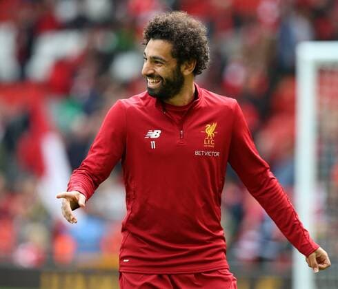 19th August 2017, Anfield, Liverpool, England; EPL Premier League football, Liverpool versus Crystal Palace; Mohammed Salah of Liverpool enjoys a joke with his team mates during the warm up before the match xDavidxBlunsdenx  ActionPlus11918758