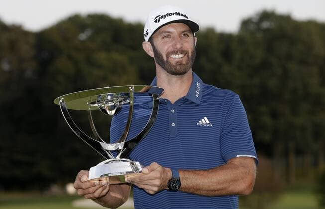Dustin Johnson holds the championship trophy on the 18th green after he makes a birdie on the first playoff hole in his playoff against Jordan Spieth in the final round of The Northern Trust golf championship at the Glen Oaks Club in Old Westbury, New York on August 27, 2017. Johnson wins The Northern Trust with a score of 13 under par.  NYP20170827119 JOHNxANGELILLO