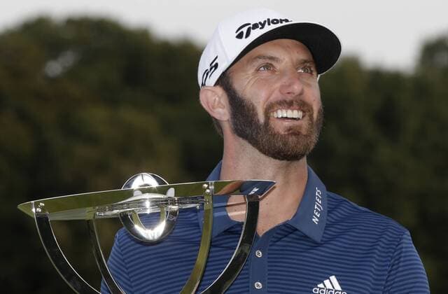 Dustin Johnson holds the championship trophy on the 18th green after he makes a birdie on the first playoff hole in his playoff against Jordan Spieth in the final round of The Northern Trust golf championship at the Glen Oaks Club in Old Westbury, New York on August 27, 2017. Johnson wins The Northern Trust with a score of 13 under par.  NYP20170827120 JOHNxANGELILLO