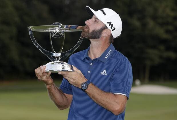 Dustin Johnson holds the championship trophy on the 18th green after he makes a birdie on the first playoff hole in his playoff against Jordan Spieth in the final round of The Northern Trust golf championship at the Glen Oaks Club in Old Westbury, New York on August 27, 2017. Johnson wins The Northern Trust with a score of 13 under par.  NYP20170827116 JOHNxANGELILLO