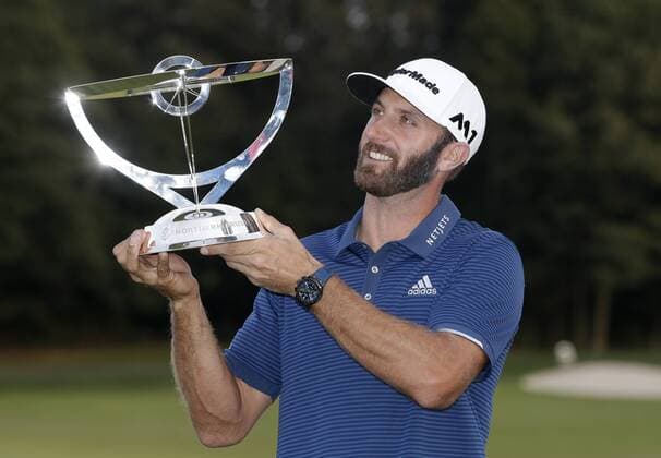 Dustin Johnson holds the championship trophy on the 18th green after he makes a birdie on the first playoff hole in his playoff against Jordan Spieth in the final round of The Northern Trust golf championship at the Glen Oaks Club in Old Westbury, New York on August 27, 2017. Johnson wins The Northern Trust with a score of 13 under par.  NYP20170827117 JOHNxANGELILLO
