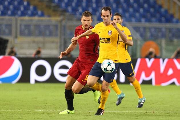 12th September 2017, Stadio Olimpic, Rome, Italy; UEFA Champions League between AS Roma versus Club Atletico de Madrid Diego Godin challenged by Dzeko ; the game ended on a 0-0 draw  ActionPlus11929539