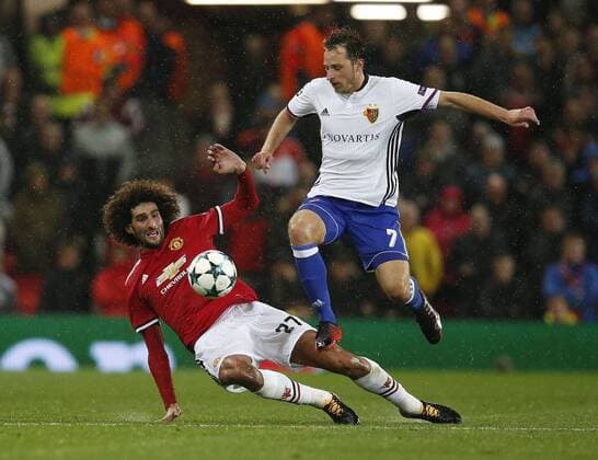 Marouane Fellaini of Manchester United ManU (L) tackles Luca Zuffi of Basel during the Champions League Group A match at the Old Trafford Stadium, Manchester. Picture date: September 12th 2017. Picture credit should read: Andrew Yates Sportimage EDITORIAL USE ONLY. No use with unauthorised audio, video, data, fixture lists, club league logos or live services. Online in-match use limited to 120 images, no video emulation. No use in betting, games or single club league player publications.