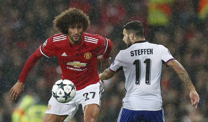 Marouane Fellaini of Manchester United ManU (L) is tackles Renato Steffen of Basel during the Champions League Group A match at the Old Trafford Stadium, Manchester. Picture date: September 12th 2017. Picture credit should read: Andrew Yates Sportimage EDITORIAL USE ONLY. No use with unauthorised audio, video, data, fixture lists, club league logos or live services. Online in-match use limited to 120 images, no video emulation. No use in betting, games or single club league player publications.