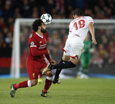 Mohamed Salah of Liverpool tussles with Sergio Escudero of Sevilla during the Champions League Group E match at the Anfield Stadium, Liverpool. Picture date 13th September 2017. Picture credit should read: Simon Bellis Sportimage EDITORIAL USE ONLY. No use with unauthorised audio, video, data, fixture lists, club league logos or live services. Online in-match use limited to 120 images, no video emulation. No use in betting, games or single club league player publications.