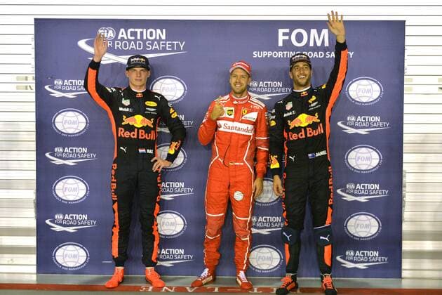 (170916) -- SINGAPORE, Sept. 16, 2017 -- Ferrari s German driver Sebastian Vettel (C) celebrates with Red Bull Racing Tag Heuer s Dutch driver Max Verstappen (L) and Australian Daniel Ricciardo after the qualifying session of the Formula One Singapore Grand Prix in Singapore on Sept. 16, 2017. ) (wll) (SP)SINGAPORE-FORMULA ONE-SINGAPORE GRAND PRIX-QUALIFYING ThenxChihxWey 