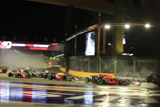 17th September 2017, Marina Bay Street Circuit, Singapore; Singapore Formula One Grand Prix, Race Day; Sebastian Vettel - Scuderia Ferrari leads race start but team mate Kimi Raikkonen and Max Verstappen - Red Bull Racing come together and also damage the car of Sebastian Vettel - Scuderia Ferrari  ActionPlus11931863