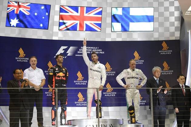 (170917) -- SINGAPORE, Sept. 17, 2017 -- Mercedes British driver Lewis Hamilton (C) celebrates with Red Bull Racing Tag Heuer s Australian Daniel Ricciardo (3rd L) and Mercedes Finnish driver Valtteri Bottas (3rd R) during the awarding cremony for the Formula One Singapore Grand Prix in Singapore on Sept. 17, 2017. ) (wll) (SP)SINGAPORE-FORMULA ONE-SINGAPORE GRAND PRIX ThenxChihxWey 