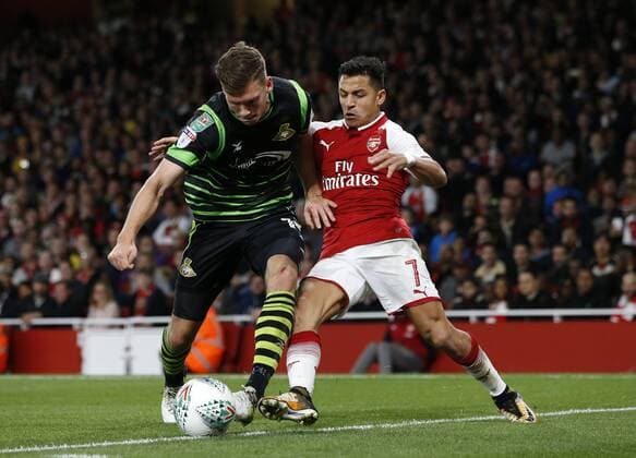 Arsenal s Alexis Sanchez tussles with Doncaster s Joe Wright during the Carabao Cup Third Round match at the Emirates Stadium, London. Picture date 20th September 2017. Picture credit should read: David Klein Sportimage EDITORIAL USE ONLY. No use with unauthorised audio, video, data, fixture lists, club league logos or live services. Online in-match use limited to 120 images, no video emulation. No use in betting, games or single club league player publications.