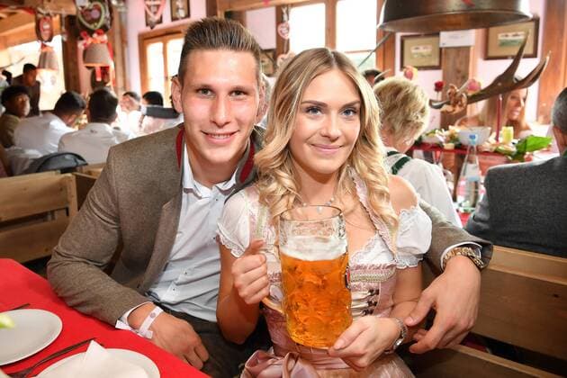 MUNICH, GERMANY - SEPTEMBER 23: Niklas Suele of FC Bayern Muenchen and his girlfriend Melissa Halter atttend the Oktoberfest beer festival at Kaefer Wiesnschaenke tent at Theresienwiese on September 23, 2017 in Munich, Germany. Muenchen