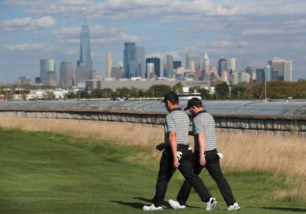 Branden Grace and Louis Oosthuizen of the International Team walk up the 14th fairway on day two of the Presidents Cup on September 29, 2017 at Liberty National Golf Club in Jersey City, New Jersey.  NYP20170929505 RICHxSCHULTZ