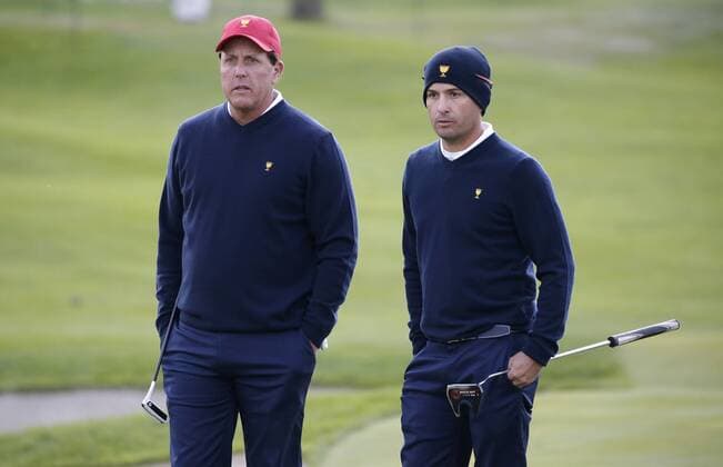 Phil Mickelson and Kevin Kisner of the United States team wait to putt in the morning foursomes matches at the Presidents Cup on September 30, 2017 at Liberty National Golf Club in Jersey City, New Jersey.  NYP20170930106 JOHNxANGELILLO