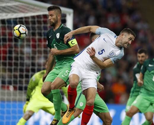 (171006) -- LONDON, Oct. 6, 2017 -- Gary Cahill (R) of England vies with Bostjan Cesar of Slovenia during the FIFA World Cup WM Weltmeisterschaft Fussball 2018 European Qualifier Group E match between England and Slovenia at Wembley Stadium, in London, Britain on Oct. 5, 2017. England won 1-0. ) (SP)BRITAIN-LONDON-FOOTBALL-WORLD CUP QUALIFIER-ENGLAND VS SLOVENIA HanxYan 