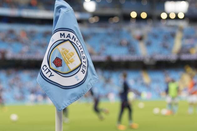 14th October 2017, Etihad Stadium, Manchester, England; EPL Premier League football, Manchester City versus Stoke City; A Manchester City corner flag with the club emblem and players warming up on the pitch  ActionPlus11940654