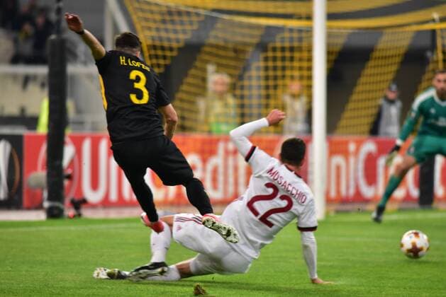Italy: AEK versus Milan Helder Lopes (no 3) of AEK shoot the ball under the pressure of Mateo Musacchio (no 22) of Milan. Athens Attiki Greece OAKA Spiros Louis  DimitriosxKarvountzisx xPacificxPress