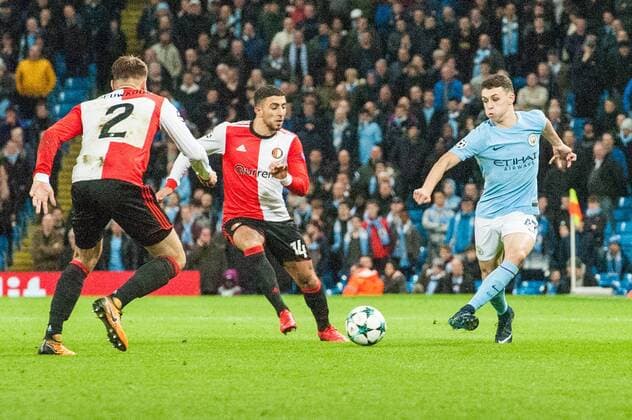 Manchester City v Feyenoord Rotterdam UEFA Champions League Phil Foden of Manchester City threads a pass past Bart Nieuwkoop (left) and Bilal Basac?koglu of Feyenoord Rotterdam during the UEFA Champions League match at the Etihad Stadium, Manchester Content Not Available For UK Newspapers Copyright: xMattxWilkinsonx FIL-10984-0052