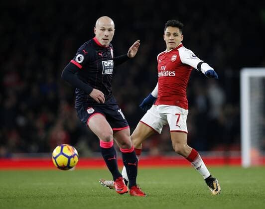 Arsenal s Alexis Sanchez tussles with Huddersfield s Aaron Mooy during the premier league match at the Emirates Stadium, London. Picture date 29th November 2017. Picture credit should read: David Klein Sportimage EDITORIAL USE ONLY. No use with unauthorised audio, video, data, fixture lists, club league logos or live services. Online in-match use limited to 120 images, no video emulation. No use in betting, games or single club league player publications.
