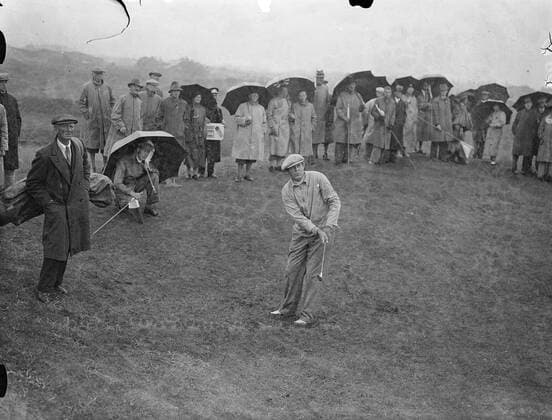 Scoring their first victory in this country, America defeated Britain by 8 to 4 in the Ryder Cup matches over the Ainsdale course at Southport, Lancashire, and retained the trophy. Ralph Guldahl of American driving off in his match against A. H. Padgham. He best Padgham 8 and 7. The crowds sheltered under umbrellas. 30 June 1937, Southport Merseyside United Kingdom England Copyright: Topfoto  UnitedArchivesEU054523