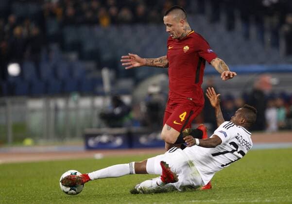 Italy: Soccer Champions League: Roma vs Qarabag Roma s Radja Nainggolan, left, is tackled by Qarabag s Donald Guerrier during the Champions League Group C soccer match between Roma and Qarabag at the Olympic stadium. Roma won 1-0 to reach the round of 16. Rome Italy  RiccardoxDexLuca PacificxPress