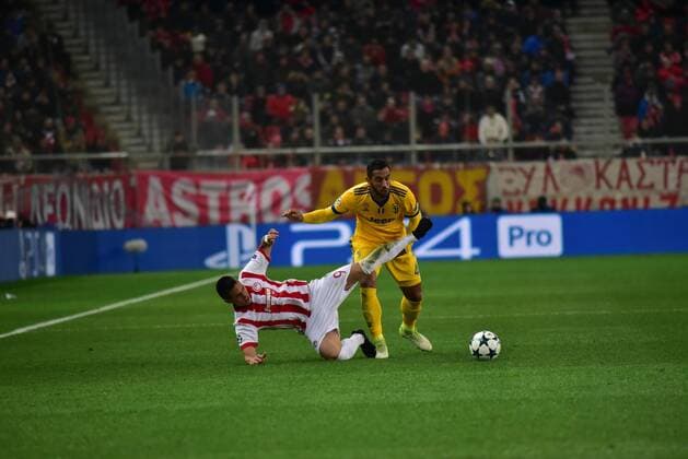 Greece: Champions League Olympiacos vs Juventus Uros Djurdjevic (no 9) of Olympiacos and Medhi Benatia (no 4) of Juventus, vies for the ball. Athens Attiki Greece G. Karaiskakis Stadium  DimitriosxKarvountzis PacificxPress