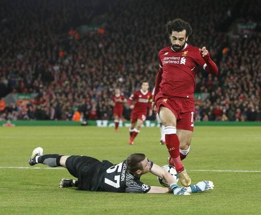 Aleksandr Selikhov of Spartak Moscow saves at the feet of Mohamed Salah of Liverpool during the Champions League Group E match at the Anfield Stadium, Liverpool. Picture date: December 6th 2017. Picture credit should read: Andrew Yates Sportimage EDITORIAL USE ONLY. No use with unauthorised audio, video, data, fixture lists, club league logos or live services. Online in-match use limited to 120 images, no video emulation. No use in betting, games or single club league player publications.