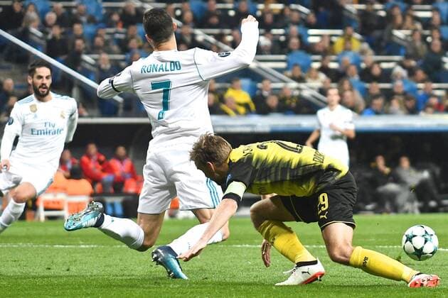 Real Madrid v Borussia Dortmund UEFA Champions League Cristiano Ronaldo of Real Madrid (left) goes down in the penalty area after a challenge by Marcel Schmelzer of Borussia Dortmund but the referee waves play on during the UEFA Champions League match at the Estadio Santiago Bernabeu, Madrid Content Not Available For UK Newspapers Copyright: xKristianxKanex FIL-11059-0029