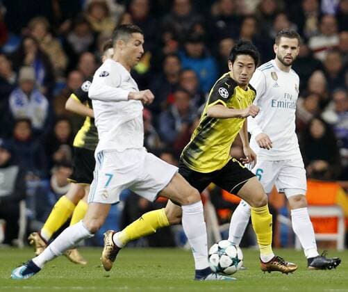Soccer: Dortmund vs Real Madrid in Champions League Real Madrid s Cristiano Ronaldo (front) dribbles the ball with Borussia Dortmund s Shinji Kagawa (2nd from R) defending during a UEFA Champions League group-stage match at Estadio Santiago Bernabeu in Madrid on Dec. 6, 2017. The Spanish team won 3-2. 