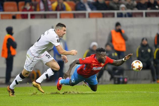 December 7, 2017 - Bucharest, Romania - Harlem Gnohere (R) of Steaua viess Vladimir Golemic of FC Lugano during the UEFA Europa League group G football match FCSB Steaua Bucuresti vs Energy Investments Lugano, on December 7, 2017 in Bucharest, Romania. Steaua Bucuresti v FC Lugano - UEFA Europa League  - ZUMAn230 20171207_zaa_n230_287 Copyright: xAlexxNicodimx