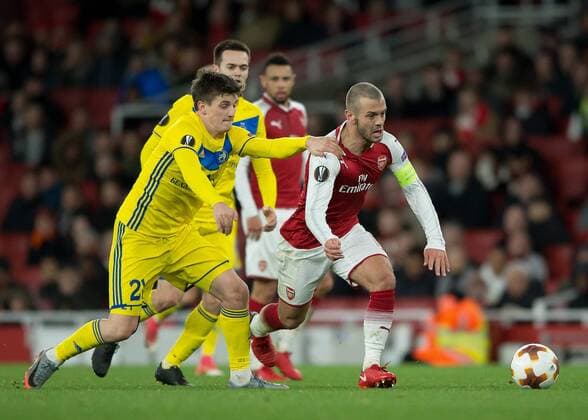 Jack Wilshere of Arsenal is held back by Stanislav Dragun of FC BATE Borisov during the UEFA Europa League match between Arsenal and BATE at the Emirates Stadium, London, England on 7 December 2017. Copyright: xVincexMignottx 18120036