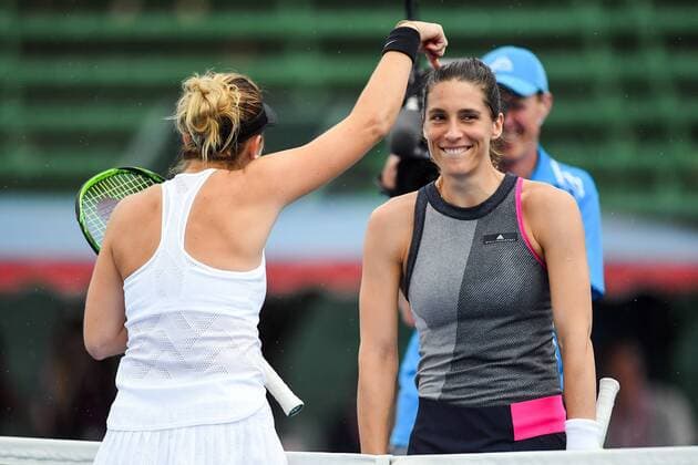 12th January 2018, Kooyong Lawn Tennis Club, Kooyong, Melbourne, Australia; Priceline Pharmacy Kooyong Classic tennis tournament; Belinda Bencic of Switzerland dances with Andrea Petkovic of Germany during rain delays in the Women s Kooyong Classic final  ActionPlus11971025
