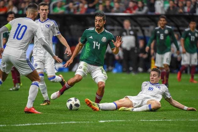 SAN ANTONIO, TX - JANUARY 31: Mexico forward Rodolfo Pizarro (14) attempts to take a shot as Bosnia and Herzegovina midfielder Dino Besirevic (18) defends during second half action during the soccer match between Mexico and Bosnia & Herzegovina on January 31, 2018 at the Alamodome in San Antonio, Texas. (Photo by Ken Murray Icon Sportswire) SOCCER: JAN 31 Mexico v Bosnia & Herzegovina Icon180131029 EDITORIAL USE ONLY
