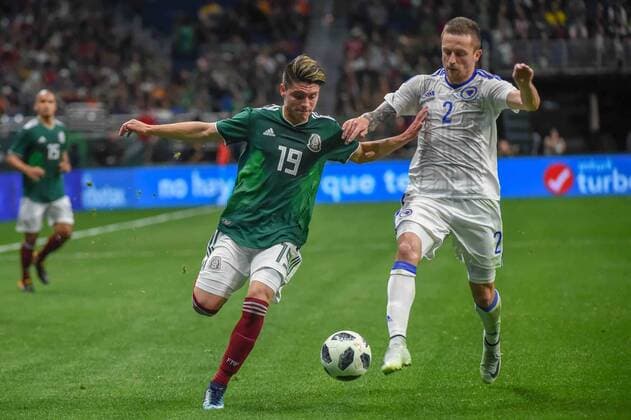 SAN ANTONIO, TX - JANUARY 31: Mexico midfielder Jonathan Gonzalez (19) and Bosnia and Herzegovina defender Almir Bekic (2) chase down a loose ball during second half action during the soccer match between Mexico and Bosnia & Herzegovina on January 31, 2018 at the Alamodome in San Antonio, Texas. (Photo by Ken Murray Icon Sportswire) SOCCER: JAN 31 Mexico v Bosnia & Herzegovina Icon180131031 EDITORIAL USE ONLY