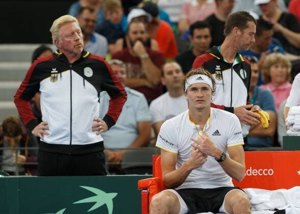 ALEXANDER ZVEREV (GER) sitzt auf der Bank waehrend der Spielpause,im Hintergrund steht Boris Becker, Davis Cup AUS_GER, Pat Rafter Arena, Brisbane Tennis - Davis Cup 2018 - ITF Davis Cup - Pat Rafter Arena - Brisbane - - Australia - 2 February 2018. Â Copyright: xJuergenxHasenkopfx