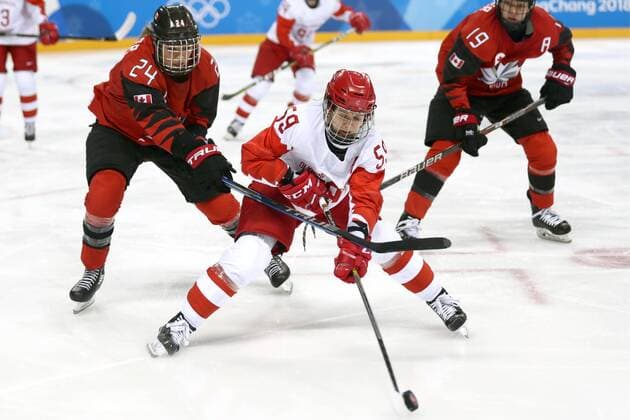 GANGNEUNG, SOUTH KOREA - FEBRUARY 11, 2018: Olympic Athlete from Russia Yelena Dergachyova (C) and Canada s Natalie Spooner (L), Brianne Jenner (R) in action in their women s preliminary round Group A Ice hockey Eishockey match at the 2018 Winter Olympic Games Olympische Spiele Olympia OS at Kwandong Hockey Centre. Valery Sharifulin TASS  TS0734EB