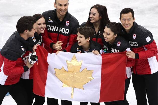 GANGNEUNG, SOUTH KOREA â€“ FEBRUARY 12, 2018: Gold medallists Scott Moir, Tessa Virtue, Eric Radford, Meagan Duhamel, Kaetlyn Osmond, Gabrielle Daleman, and Patrick Chan (L-R) of Canada waving a Canadian national flag as they pose at a flower ceremony for the Figure skating Eiskunstlauf team event at the 2018 Winter Olympic Games Olympische Spiele Olympia OS at the Gangneung Ice Arena. Valery Sharifulin TASS  TS0736AE