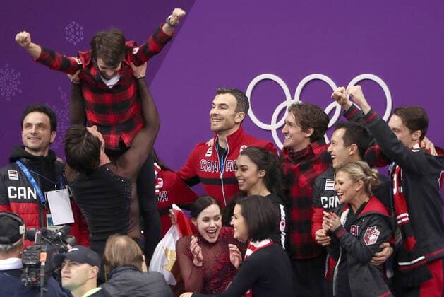 GANGNEUNG, SOUTH KOREA â€“ FEBRUARY 12, 2018: Ice dancers Tessa Virtue and Scott Moir of Canada and their coach Marie-France Dubreuil (in the middle) react as they learn the score after preforming their free dance as part of the Figure skating Eiskunstlauf team event at the 2018 Winter Olympic Games Olympische Spiele Olympia OS at the Gangneung Ice Arena. Pictured back is figure skaters Meagan Duhamel, Eric Radford, Gabrielle Daleman, and Patrick Chan. Valery Sharifulin TASS  TS0736D5