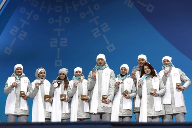 PYEONGCHANG, SOUTH KOREA – FEBRUARY 12, 2018: Olympic Athletes from Russia Mikhail Kolyada, Evgenia Medvedeva, Alina Zagitova, Yevgenia Tarasova, Vladimir Morozov, Natalya Zabiyako, ALEXANDER Enbert, Ekaterina Bobrova, and Dmitri Soloviev (L-R) pose with their silver medals during the victory ceremony for the Figure skating Eiskunstlauf team event at the 2018 Winter Olympic Games Olympische Spiele Olympia OS Valery Sharifulin TASS TS07374A
