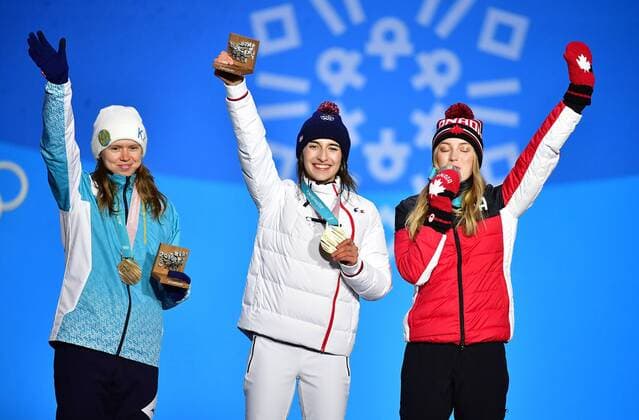 Bronze medalist Kazakstan s Yulia Galysheva (L), gold medalist France s Perrine Laffont (C), and silver medalist Canada s Justine Dufour-Lapointe pose together during the medal ceremony for Ladies Moguls during the Pyeongchang 2018 Winter Olympics in Pyeongchang, South Korea, on February 12, 2018.  OLY20180212344 KEVINxDIETSCH