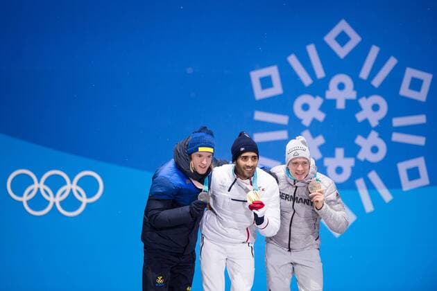 180213 Sebastian Samuelsson of Sweden, silver, Martin Fourcade of France, Gold, and Benedikt Doll of Germany, Bronze, celebrates at the medal ceremony for the Men s Biathlon 12,5 km Pursuit during day four of the 2018 Winter Olympics on February 13, 2018 in Pyeongchang. Photo: Jon Olav Nesvold BILDBYRAN kod JE 160160 Copyright: JONxOLAVxNESVOLD BB180213JE087