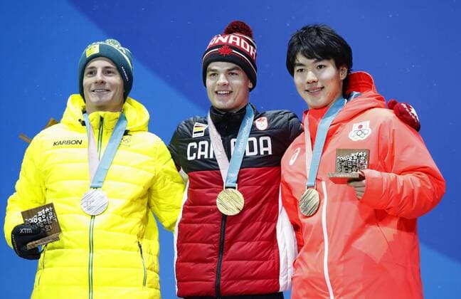 Pyeongchang Olympics Gold medalist Mikael Kingsbury (C) of Canada, silver medalist Matt Graham (L) of Australia and bronze medalist Daichi Hara of Japan attend the medal ceremony for the men s freestyle skiing moguls at the Pyeongchang Winter Olympics in South Korea on Feb. 13, 2018. 