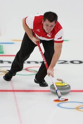 Martin Rios of Switzerland sweeps during the Gold Medal Mixed Doubles game against Canada at the Gangneung Curling Center in Gangneung, South Korea during the 2018 Pyeongchang Winter Olympics on February 13, 2018. Canada won 10-3.  OLY20180213821 ANDREWxWONG