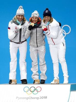 OLYMPICS - 2018 Winter Olympics PYEONGCHANG,SOUTH KOREA.13.FEB.18 - OLYMPICS,BIATHLON - Olympic Winter games Winterspiele Spiele Summer games PyeongChang 2018, Medals Plaza, 10km Pursuit, ladies, award ceremony. Image shows Anastasiya Kuzmina (SVK), Laura Dahlmeier (GER) and Anais Bescond (FRA). Keywords: medals. GEPAxpictures xMaticxKlansek