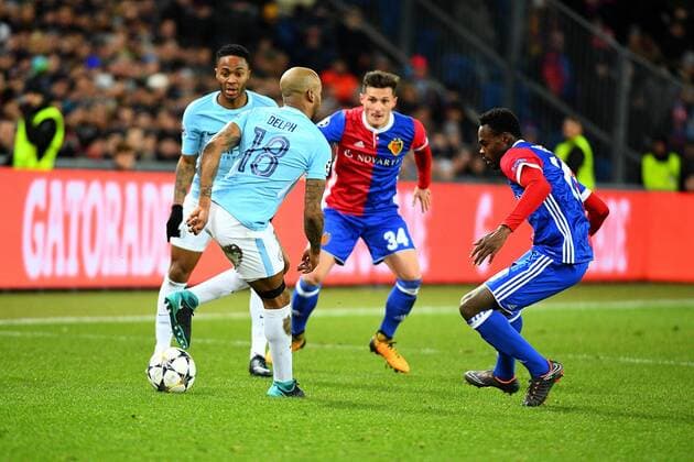 13th February 2018, St Jakob Park, Basel, Switzerland; UEFA Champions League football, round of 16, first leg, FC Basel versus Manchester City; Dimitri Oberlin of FC Basel challenges Fabian Delph of Manchester City for the ball while Raheem Sterling of Manchester City and Taulant Xhaka of FC Basel look on  ActionPlus11986670