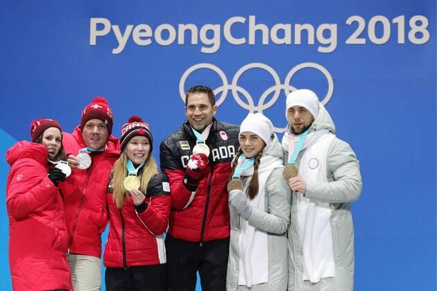 PYEONGCHANG, SOUTH KOREA - FEBRUARY 14, 2018: Silver medalists, Switzerland s Jenny Perret and Martin Rios, Gold medalists, Canada s Kaitlyn Lawes and John Morris and Bronze medalists, Olympic Athletes from Russia Anastasia Bryzgalova and Aleksandr Krushelnitckii (L-R) during a medal ceremony for the curling mixed doubles competition at the 2018 Winter Olympic Games Olympische Spiele Olympia OS at Medals Plaza. Sergei Bobylev TASS  TS073C05