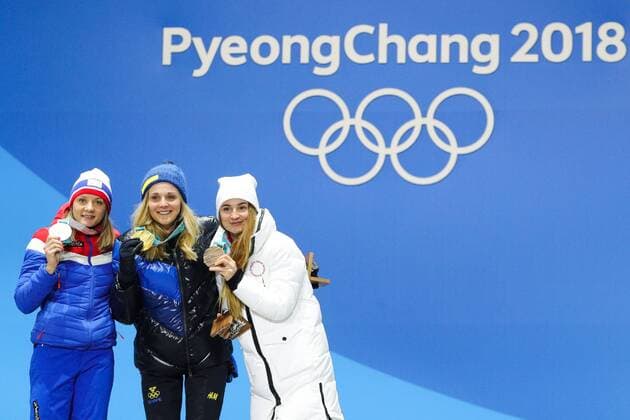 PYEONGCHANG, SOUTH KOREA - FEBRUARY 14, 2018: Silver medalist, Norway s Maiken Caspersen Falla, Gold medalist, Sweden s Stina Nilsson and Bronze medalist, Olympic Athlete from Russia Yulia Belorukova (L-R) at a medal ceremony for the ladies cross-country skiing individual sprint classic event at the 2018 Winter Olympic Games Olympische Spiele Olympia OS at Medals Plaza. Sergei Bobylev TASS  TS073C33