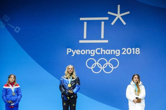 PYEONGCHANG, SOUTH KOREA - FEBRUARY 14, 2018: Silver medalist, Norway s Maiken Caspersen Falla, Gold medalist, Sweden s Stina Nilsson and Bronze medalist, Olympic Athlete from Russia Yulia Belorukova (L-R) at a medal ceremony for the ladies cross-country skiing individual sprint classic event at the 2018 Winter Olympic Games Olympische Spiele Olympia OS at Medals Plaza. Sergei Bobylev TASS  TS073C40
